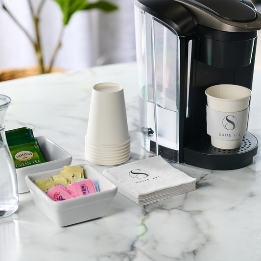 A collection of custom cocktail napkins featuring brand logos